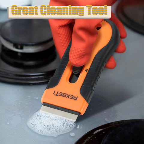 Razor Blade Scraper Tool Set 2 Pack With 80 Replacement Blades, orange and black, cleaning soapy residue on stovetop.