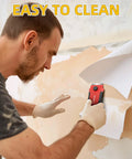Man using Razor Blade Scraper With 15 Extra SK5 Blades And Built In Blade Storage Non Retractable Rubber Handle Cleaner for paint removal on wall.