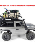 Model RC crawler with assorted mini bungee cords and rooftop gear for small item securing and travel use.