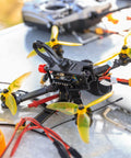 Drone with installed anti vibration rubber balls set for RC flight controllers F4 and F7 M3x8mm mounting, yellow props.