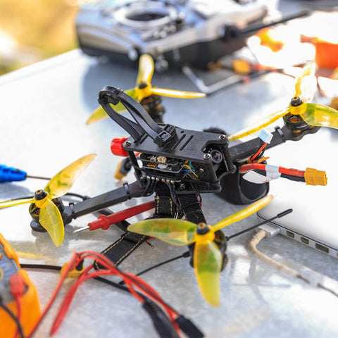 Drone with installed anti vibration rubber balls set for RC flight controllers F4 and F7 M3x8mm mounting, yellow props.