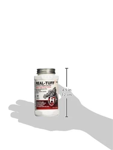 Real-Tuff Heavy Duty PTFE Pipe Thread Sealant in white bottle, 8 oz, shown in hand; suitable for metal and plastic plumbing projects.