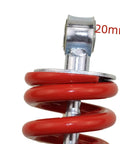 Close-up of a red spring and metal mount on a Rear Shock Absorber 270 Millimeter Center To Center Mounting For Quad ATV Dirt Bike Pit Bike Go Kart Buggy 980 Pound Load With Sensa Trac Suspension Durable Beefed Up Heavy Duty Built To Last For 4 Wheel Vehicles.
