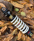 Rear Shock For Dirty Pit Bike With Adjustable Rebound And Dual Spring Options 250lb Or 350lb on autumn leaves