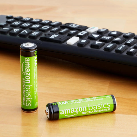 Rechargeable AAA NiMH Batteries 800 mAh Low Self Discharge Precharged 12 Pack next to remote control on table