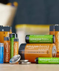Assorted batteries including Amazon Basics AAA rechargeables, AA lithium, and D cell alkaline, displayed together on a table.