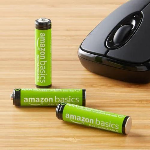 Rechargeable AAA NiMH Batteries 800 mAh Low Self Discharge Precharged 12 Pack next to a computer mouse on a wooden surface