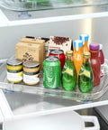 Clear Rectangular Refrigerator Lazy Susan Organizer With 360 Degree Rotation And Pullout Design holding bottles and cans.
