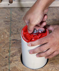 Plastic End Of Pipe Plug With Galvanized Screw And Wing Nut For 4 Inch Red Pipes being installed on pipe end