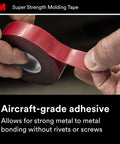 Person holding 3M heavy-duty automotive molding tape 7/8 inch wide by 15 feet, double-sided foam adhesive roll for trim installation.