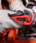 Person using Cable Stripper for AWG 12 to 4/0 Round Cables With Radial Cutting Design on black cable, wearing protective gloves.