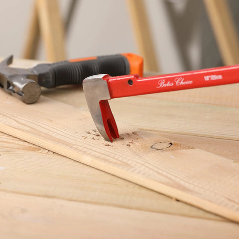 Cat's Paw Nail Puller Set Three Piece Pry Bar Kit Includes 8 Inch 10 Inch And 12 Inch Nail Removers With Red Coated Grips For Fast Nail Tacks And Staples Extraction From Wood Furniture Flooring And Demolition Projects showing red-handled pry bar extracting a nail from wooden board.