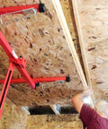 Person using ✝️ Drywall Lift 11' Drywall Panel Hoist Construction Rolling Caster Wheel Lockable Tool Jack Lifter to install ceiling panels.