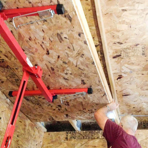 Person using ✝️ Drywall Lift 11' Drywall Panel Hoist Construction Rolling Caster Wheel Lockable Tool Jack Lifter to install ceiling panels.