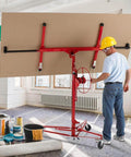 Man using ✝️ Drywall Lift 11' Drywall Panel Hoist Construction Rolling Caster Wheel Lockable Tool Jack Lifter Jack Drywall Lift Construction Tools (Red) in room.