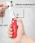 Hands holding red 4-pack folding utility knife with quick-change blades and back-lock, showing blade replacement for safe box opening.