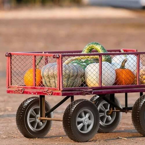Red garden cart with pumpkins and "✝️ (2-pack) 10" x 2.5" solid rubber tire wheels, 10 inch tire and wheel flat free with 5/8" bearings, 2.1" offset hub replacement wheelbarrow tires- perfect for hand truck, wheelbarrow, garden cart built for smooth motion, steady alignment, and" visible