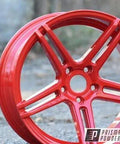 Astatic Red Solid Tone Polyester Powder Coating 1 LB High Gloss Finish for automotive metal wheel, high-gloss red rim outdoors.