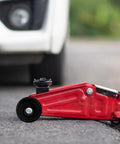 Universal Steel Front Wheel Replacement for Hydraulic Floor Jacks in use, showing smooth mobility on red jack.