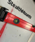 Red level mounted on wall with yellow universal level holder 2 pack for secure storage.