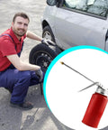 Mechanic with Metal Car Oil Can Pump Oiler With Precision Nozzle Manual Refueling Dispenser for Motor Oil beside a vehicle.