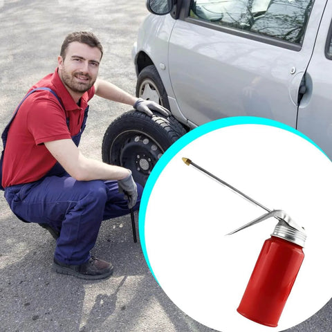 Mechanic with Metal Car Oil Can Pump Oiler With Precision Nozzle Manual Refueling Dispenser for Motor Oil beside a vehicle.