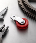 Red Fiberglass Reinforced Nylon Pulley with tools for baseball batting cage netting cable system, durable 1-3/4" pulley.