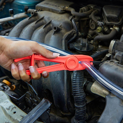 Three Pack Hose Pinch Off Pliers In Red Nylon For Automotive Fuel Line Clamps And Brake Radiator And Coolant Hoses Heat Resistant And Nonconductive Clamp Tool Set For Safe Fluid Line Maintenance in use on vehicle engine hose