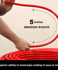 Person demonstrating 5-inch bending radius of Pex A Tubing 1 Inch 100 Ft Coil Red Non Barrier Flexible PEX Pipe for potable water.