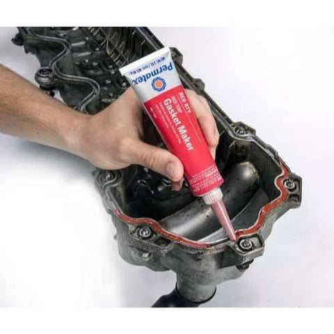 Applying High-Temp Red RTV Silicone Gasket Maker, 3 Oz, Go-To Heavy-Duty Sealant for replacing cut gaskets on engine part