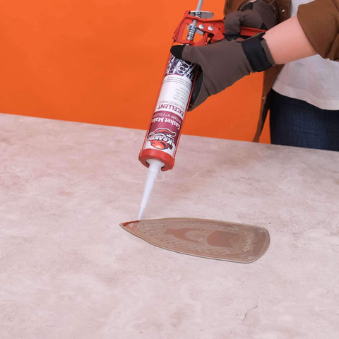 Person applying Red RTV Silicone Gasket Maker Sealant, Heavy Duty Automotive Grade, Oil Resistant And Heat Safe Up To 600F