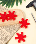 Flexible L095 NBR Rubber Spider Insert Set For L Jaw Couplings, 4 pack in red on a wooden tray with caliper and screwdriver nearby.