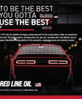 Rear view of a red sports car with Red Line Oil branding in a dimly lit automotive setting.