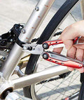 Using 10-In-1 Stainless Steel Multitool With Safety Lock And Red Nylon Sheath Including Needle Nose Pliers on bicycle
