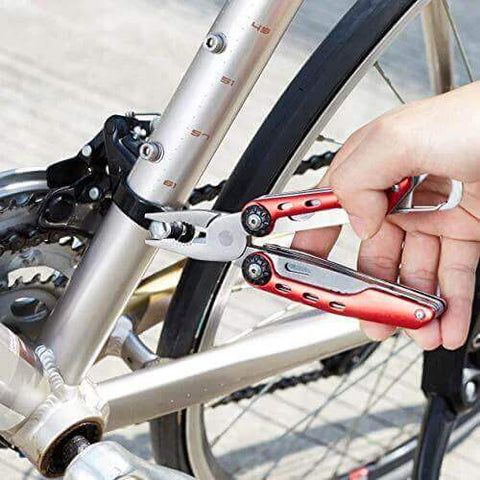 Using 10-In-1 Stainless Steel Multitool With Safety Lock And Red Nylon Sheath Including Needle Nose Pliers on bicycle