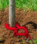 Beefy Heavy Duty Pallet Puller Clamp 1 Ton Steel Single Scissor Hook installed around tree trunk on soil