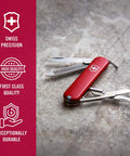 Victorinox Swiss Army Classic SD Pocket Knife Red Ultra Compact Seven Function Tool with open tools on stone surface