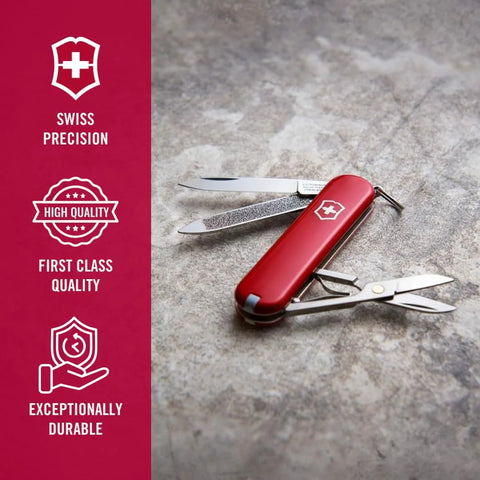 Victorinox Swiss Army Classic SD Pocket Knife Red Ultra Compact Seven Function Tool with open tools on stone surface
