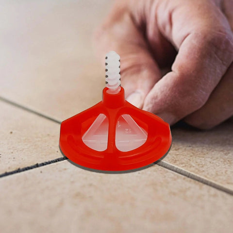 Close-up of One Eighth Inch Tile Leveling System With Spiral Spacers And Red Reusable Caps installed on tile floor