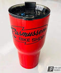 Red tumbler with logo, coated with Astatic Red Solid Tone Polyester Powder Coating 1 LB High Gloss Finish For Automotive Metal Wheels And Parts Durable High Performance Coating Proudly Made In The USA 85 Plus Gloss Units