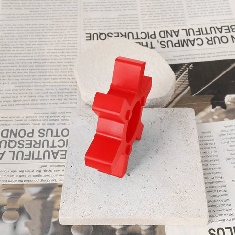Red urethane jaw coupling insert L110 two pack for Lovejoy style L-jaw couplings on a stone tile with newspaper background.
