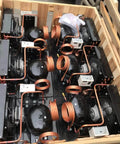 Crate of HVAC components with copper parts, illustrating Refrigerator Filter Dryer With Access And Service Valve And Three In One HVAC Tool Kit
