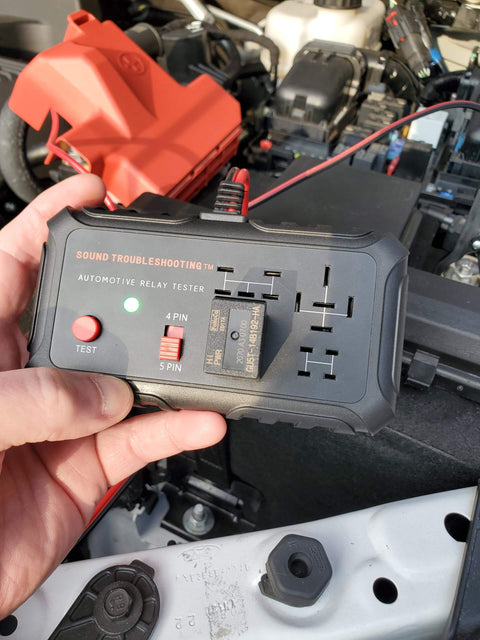 Person holding Automotive Relay Tester With Puller For 12V Cars And Trucks, DIY Friendly Relay Diagnostic Tool with LED indicators.