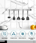 Kitchen holder with hanging utensils against a tiled backsplash, featuring removable, stable hold, free scratch, and one snap to hang features.