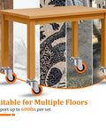 Close-up of table with Replacement Casters Set Of 4 For Wet Dry Vacuums, 2 Inch Stem, 600 Pound Weight Capacity, orange wheels on floor.