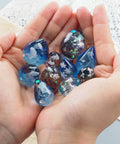 Hands holding colorful resin pendants made with Mini Egg And Waterdrop Silicone Molds Set Six Pieces Clear Resin Molds for DIY crafts