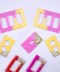 Colorful epoxy resin light switch and outlet covers made with 7 Piece Light Switch Cover Resin Molds Set for Epoxy Resin Crafts.
