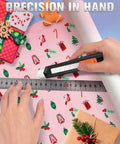 Four pack retractable utility knife with 18mm snap off blades cutting wrapping paper with ruler guide, in home workshop