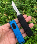 Auto retractable utility knife with push button deployment, showing two knives in black and blue with textured grips for safe cutting.