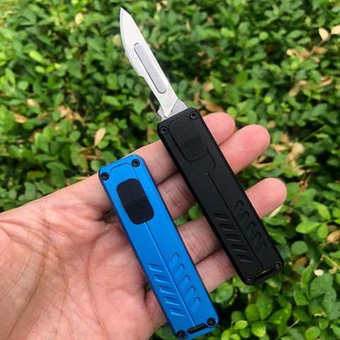 Auto retractable utility knife with push button deployment, showing two knives in black and blue with textured grips for safe cutting.